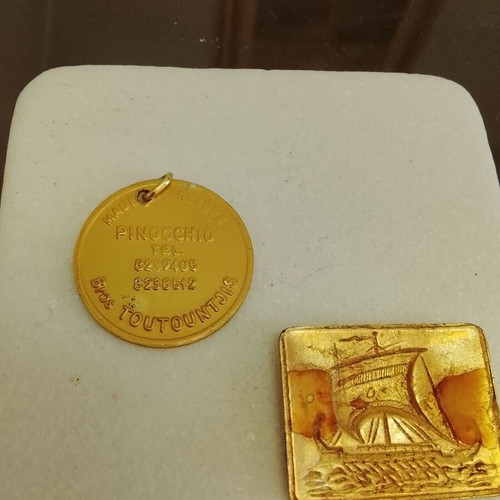 Vintage advertising keychain Pinocchio and metal trireme badge used