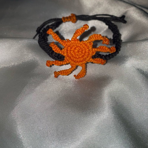 Macrame bracelet like new with adjustable fastening, black and orange