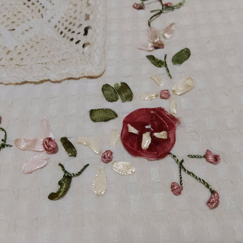 Embroidered tablecloth like new with satin ribbon and floral motifs