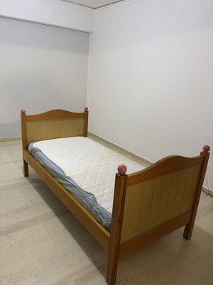Single wooden bed with mattress, natural wood finish, pink details