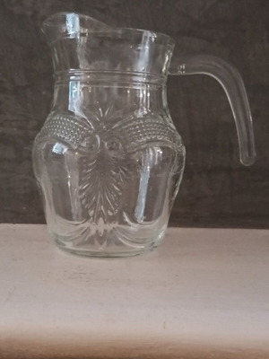 Vintage glass pitcher with embossed carvings like new