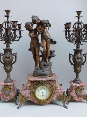 Metal clock with adolescent statues and marble base, French made