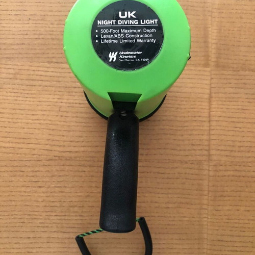 Underwater Kinetics UK1200 halogen underwater flashlight used with handle and strap