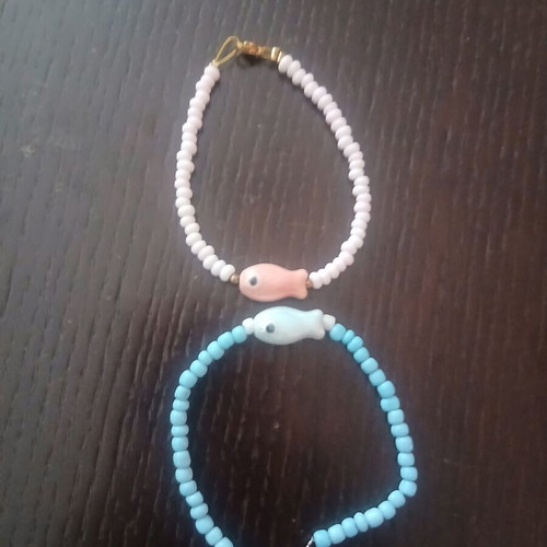 Two handmade island-style bracelets with beads and stone fish