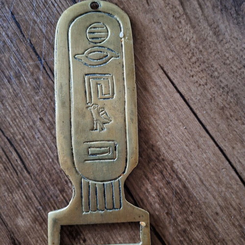 Brass bottle opener with Egyptian hieroglyphs used, 15 cm