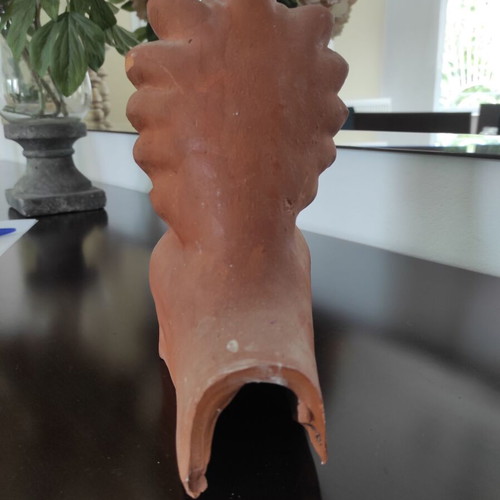 Traditional clay acroterion (anthemion) depicting the form of the God Hermes