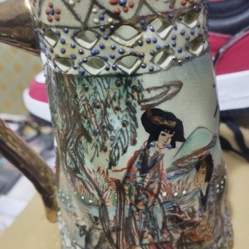 Collectible ceramic pitcher with embossed decorations, new