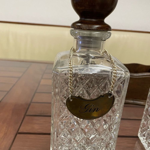 Vintage English decanters used in wooden stand for gin, cognac, whisky