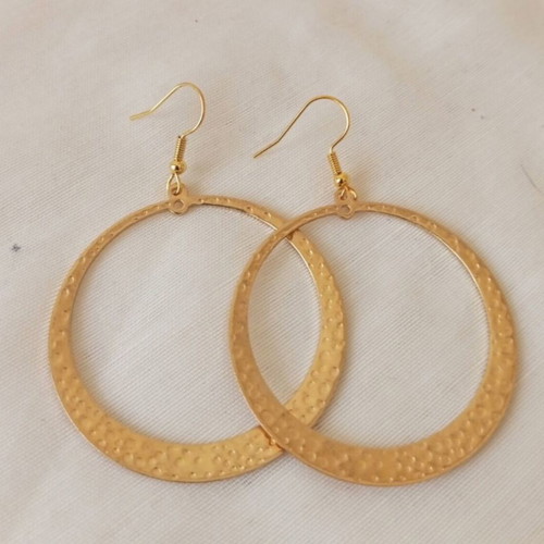 Large gold-tone hoop earrings with embossed hammered surface