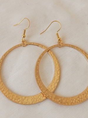 Large gold-tone hoop earrings with embossed hammered surface