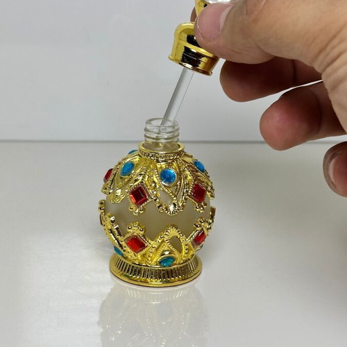 Vintage Arabic perfume bottle with gold metal frame and stones