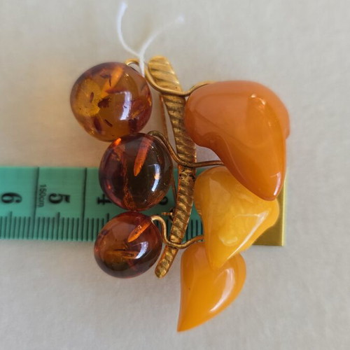 Baltic amber brooch with grape cluster design