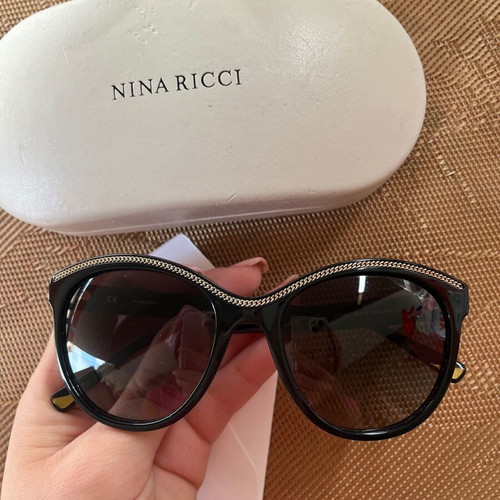 Nina Ricci SNR097 sunglasses like new, black oval acetate frame with chain design
