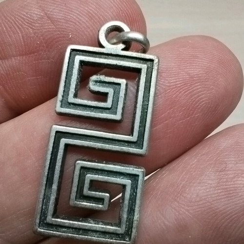 Pendant with double Meander like new, silver color