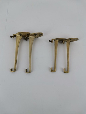 Pair of brass curtain hooks with clamp used