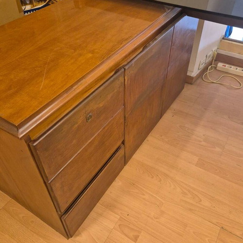Corner desk with glass surface used, wooden base and storage