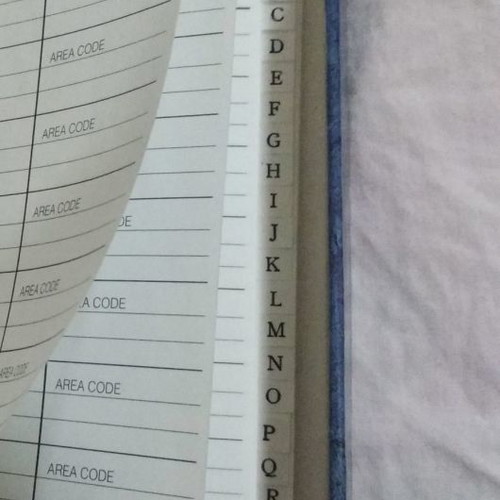 Phone book with magnetic closure and pen holder