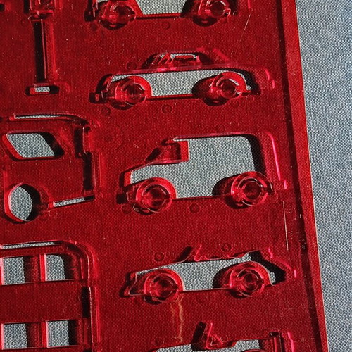 Red plastic stencil with vehicle designs