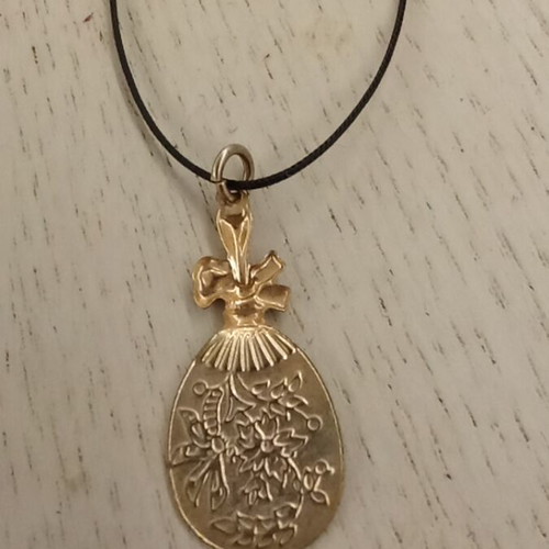 Handmade metal pendant with silver clasp and synthetic silk cord like new