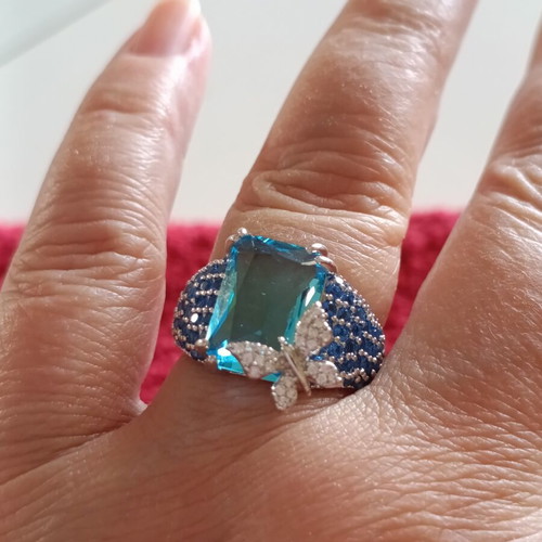 Women's ring new with emerald cut blue stone and butterfly detail