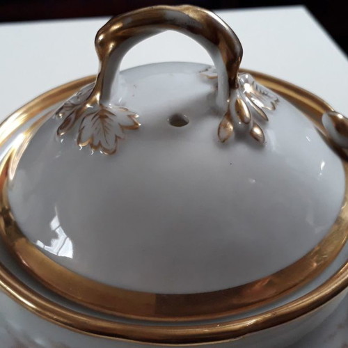 Antique porcelain teapot with wooden handle used