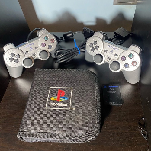 PlayStation 2 used accessory pack with 2 silver controllers, CD case and memory card