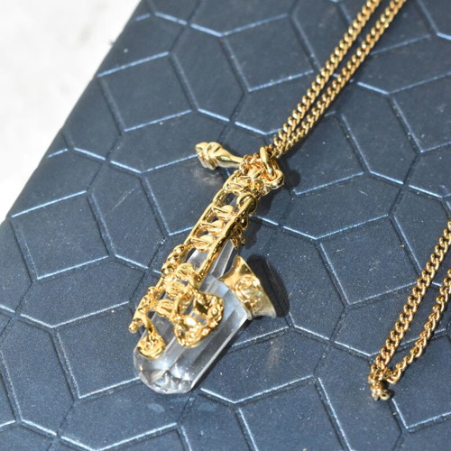Swarovski necklace with saxophone pendant and crystal like new, gold plated