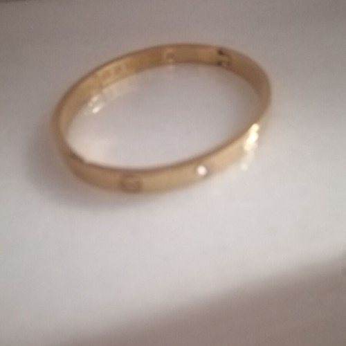 Steel bracelet with clip and rhinestones, gold color