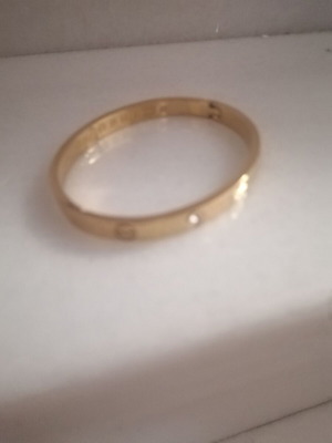 Steel bracelet with clip and rhinestones, gold color