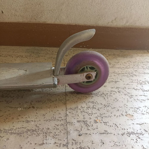Silver metal scooter used, lightweight and foldable