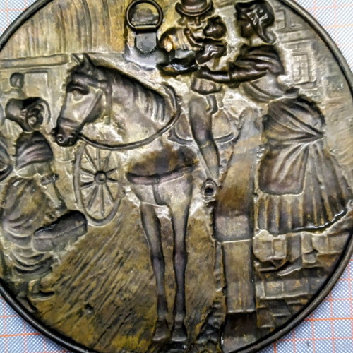 Vintage round brass plate used with embossed scene