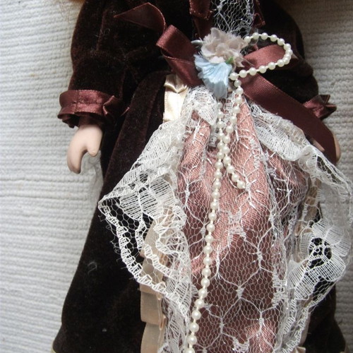 Porcelain doll used with base, box and accessories