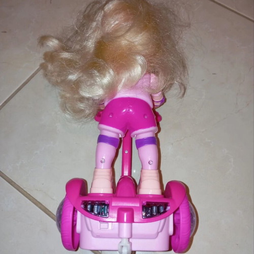 Doll on electric scooter with songs and lights, like new