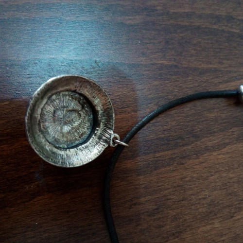 Pendant with purple glass cabochon on leather strap used