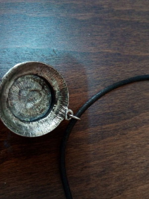 Pendant with purple glass cabochon on leather strap used