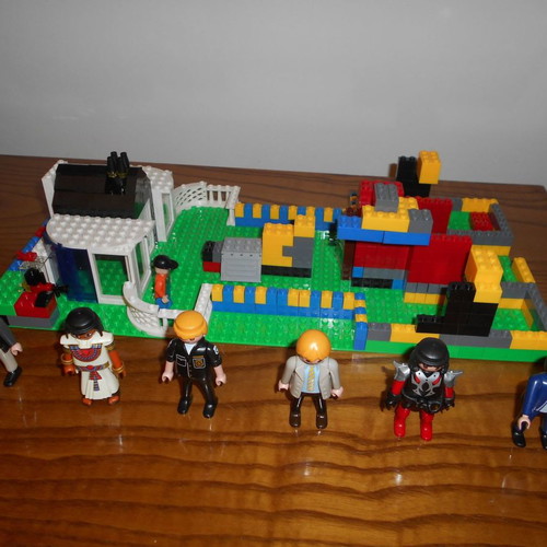 Building toy with Lego bricks and 6 Play Mobil figures used