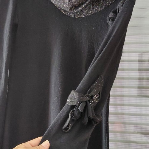 Women's black knitted winter dress with silver details and flower