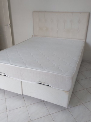 Double bed with mattress and large storage space, fabric headboard, white/cream