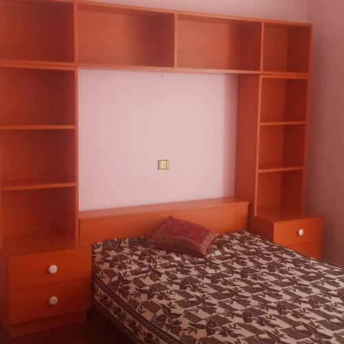 Wooden bedroom set with bed, mattress, nightstands, bookshelf, dresser with mirror