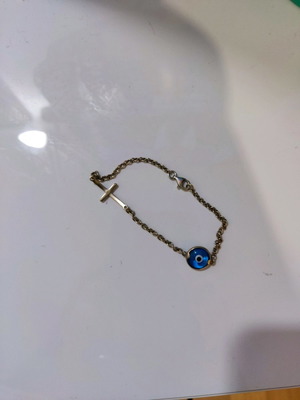 Silver bracelet used with evil eye and cross charm