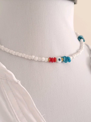 Summer women's white necklace made of glass beads with corals, an eye charm, and turquoise shells