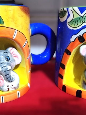 Decorative ceramic mugs set of 2 with embossed animal designs like new