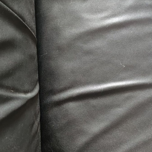 Black leather three-seater sofa used with coffee tables