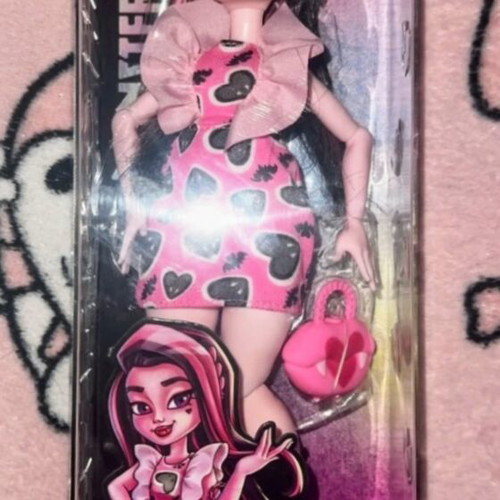 Monster High Draculaura doll with pink mini dress and accessories