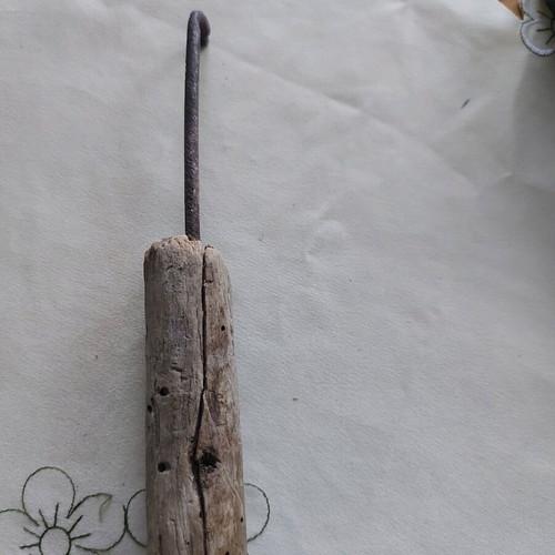 Vintage tool used, wooden part damaged, likely screwdriver