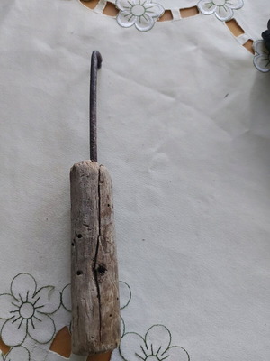 Vintage tool used, wooden part damaged, likely screwdriver