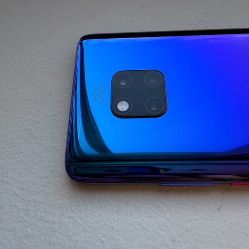 Huawei Mate 20 Pro smartphone with charging cable, cracked screen