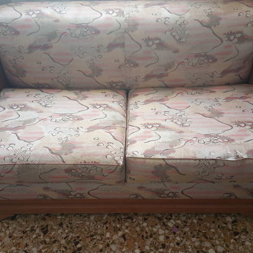 Two-seater sofa bed with wooden frame and rattan sides