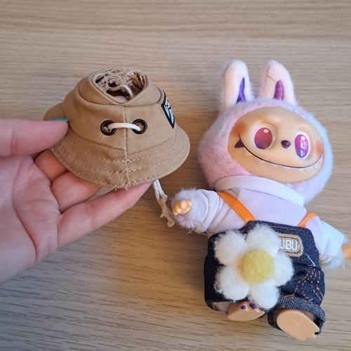Labubu doll with pastel pink, purple, and blue clothes like new