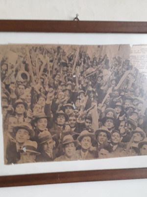 Newspaper scrap used from 1932 student rally in wooden frame